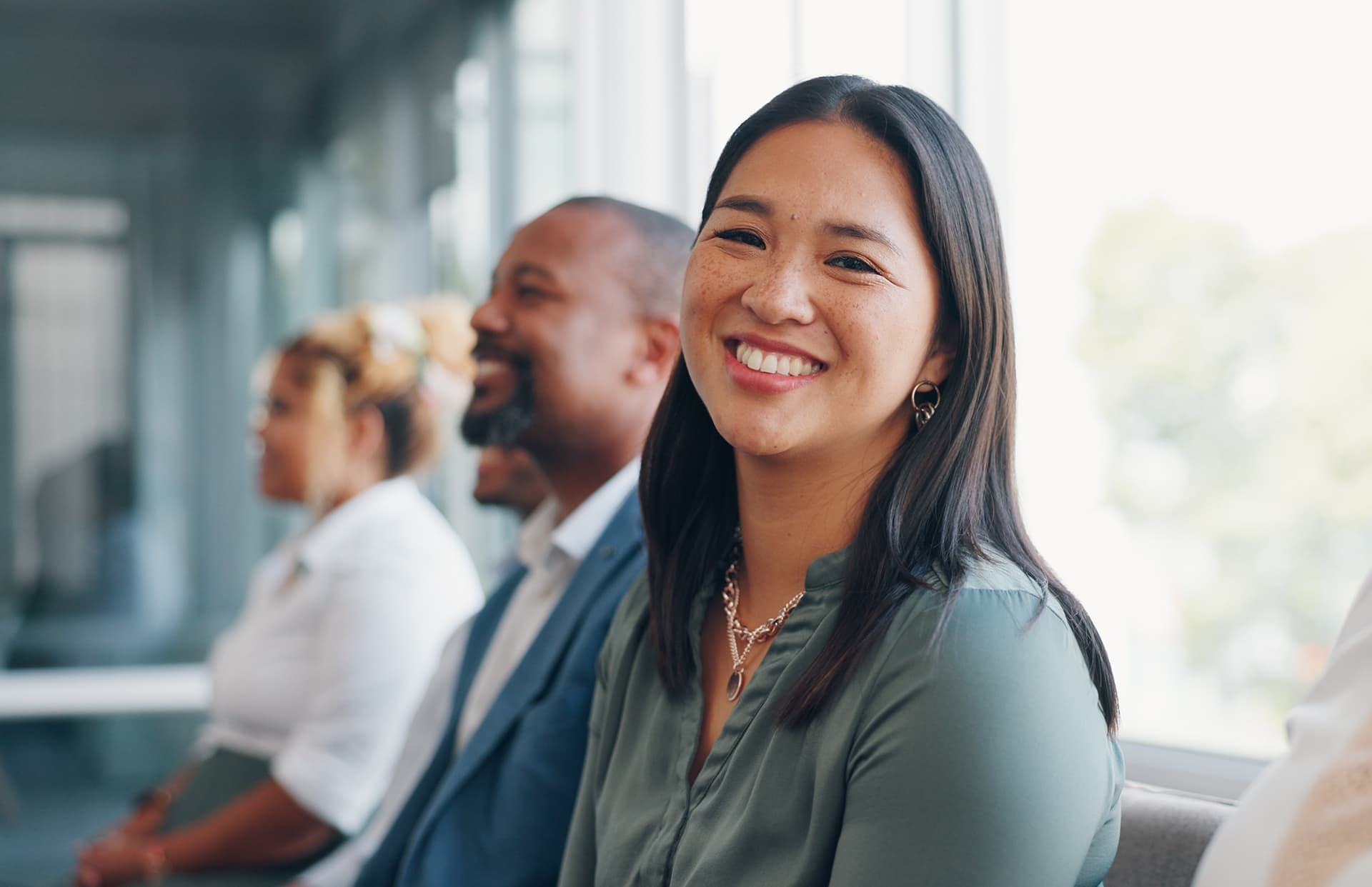 Face, recruitment or business people in a waiting room for a job interview at human resources office building. Portrait, we are hiring or excited woman in queue for an advertising agency or company