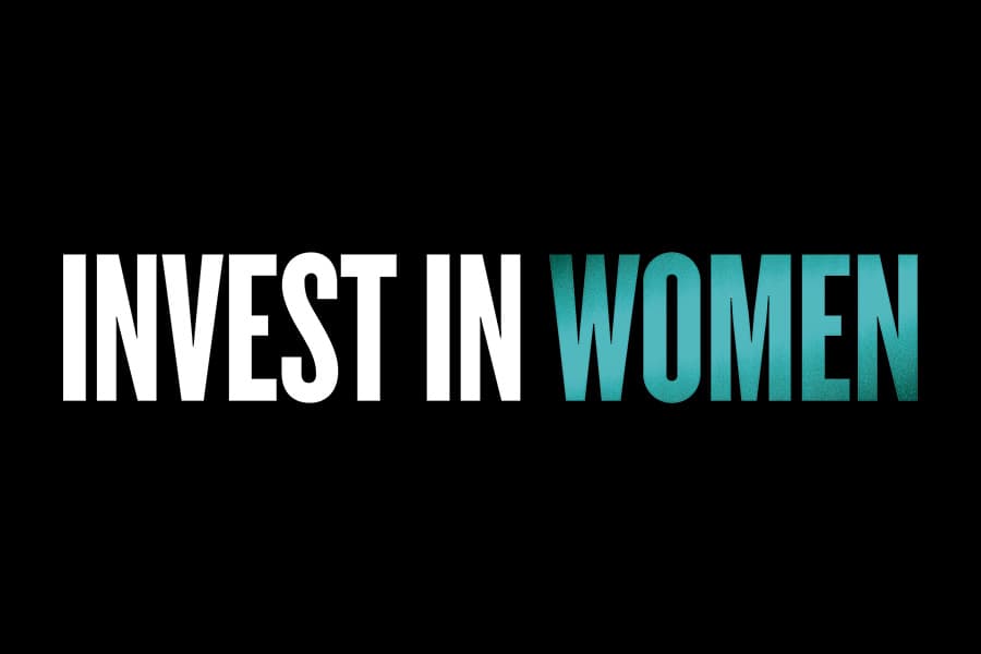 The text "INVEST IN WOMEN" displayed against a black background, with the word "WOMEN" in teal and the rest of the text in white.