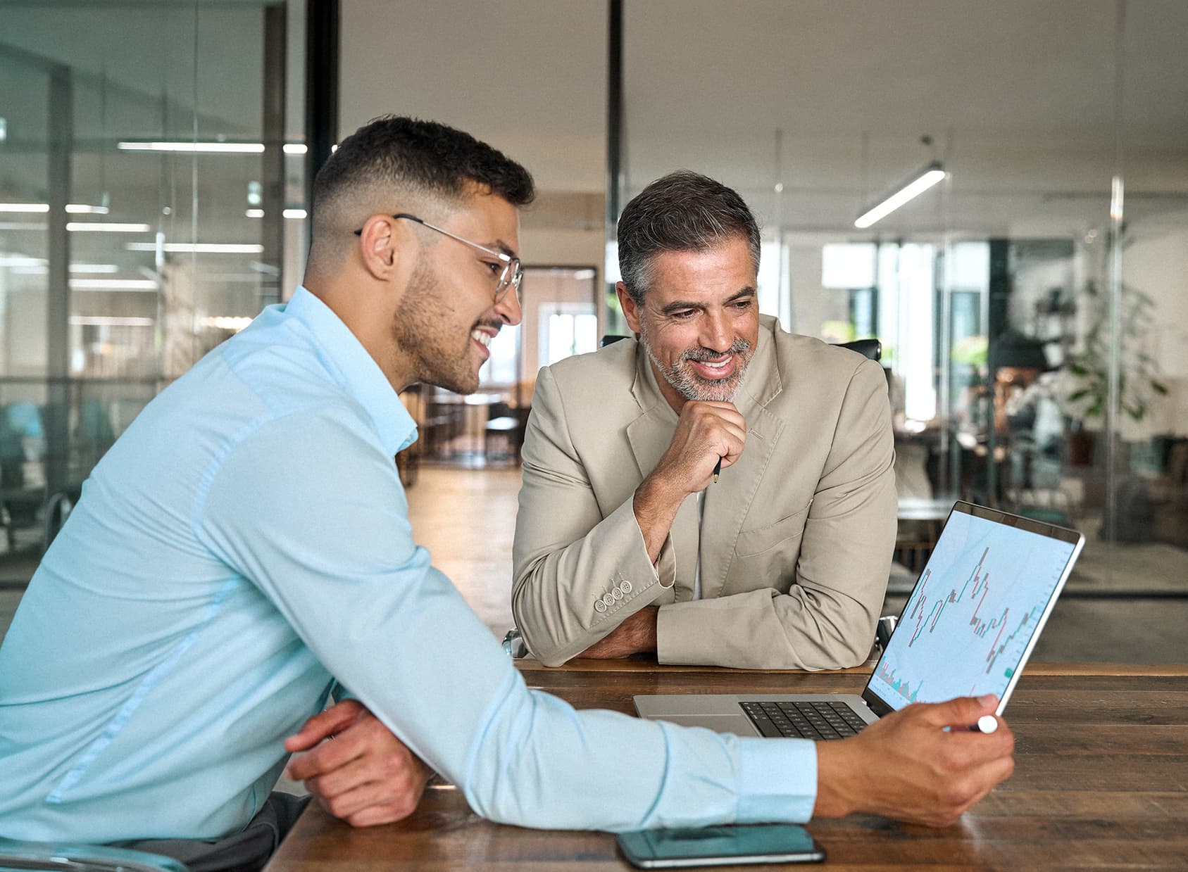 Financial advisor consulting investor explaining financial trade stock data using laptop computer. Professional analyst showing market trends in crypto exchange planning investment at office meeting.