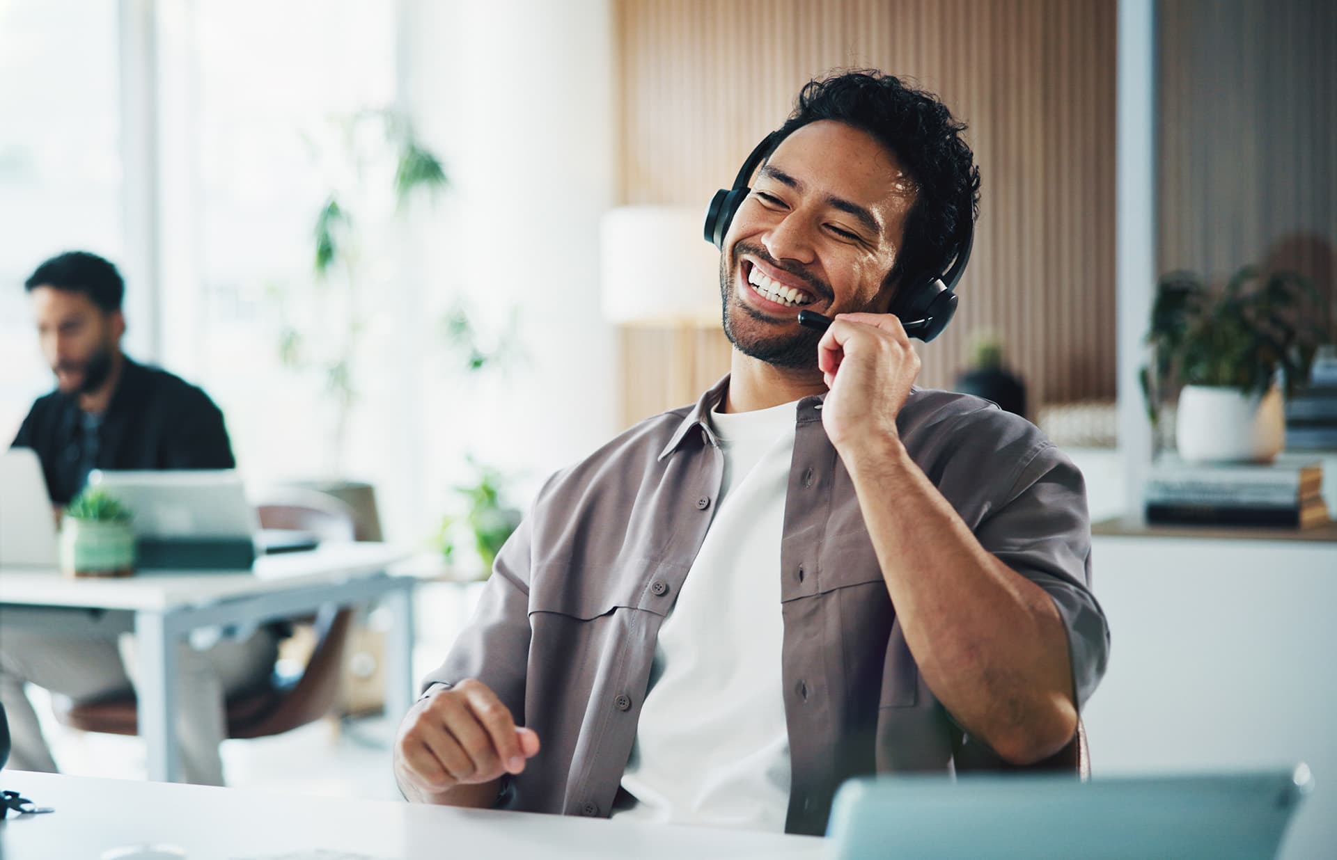 Call center, laugh and businessman with headset in office for crm, customer service or helpdesk. Communication, computer and male consultant with mic for technical support, contact us or advice.